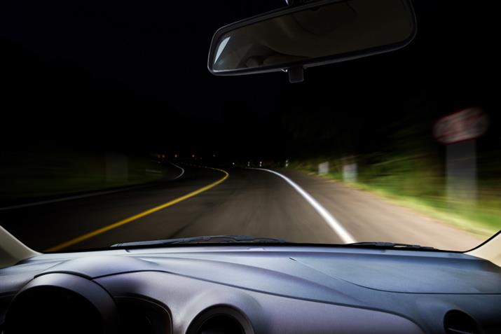 Driving with high beams on a dark road
